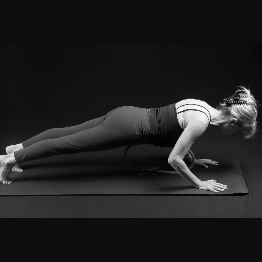 Florence in a kneeling plank with a magic circle
