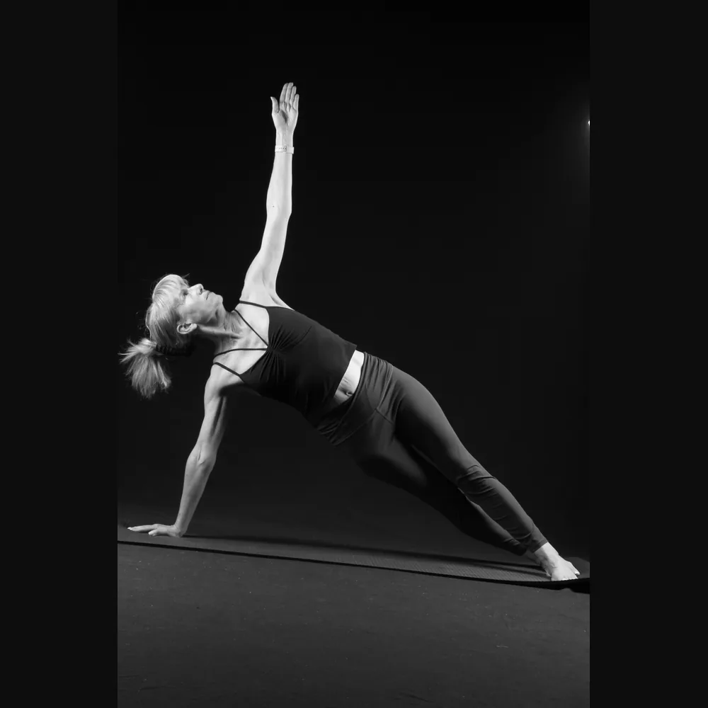 Florence in a side plank with arm raised