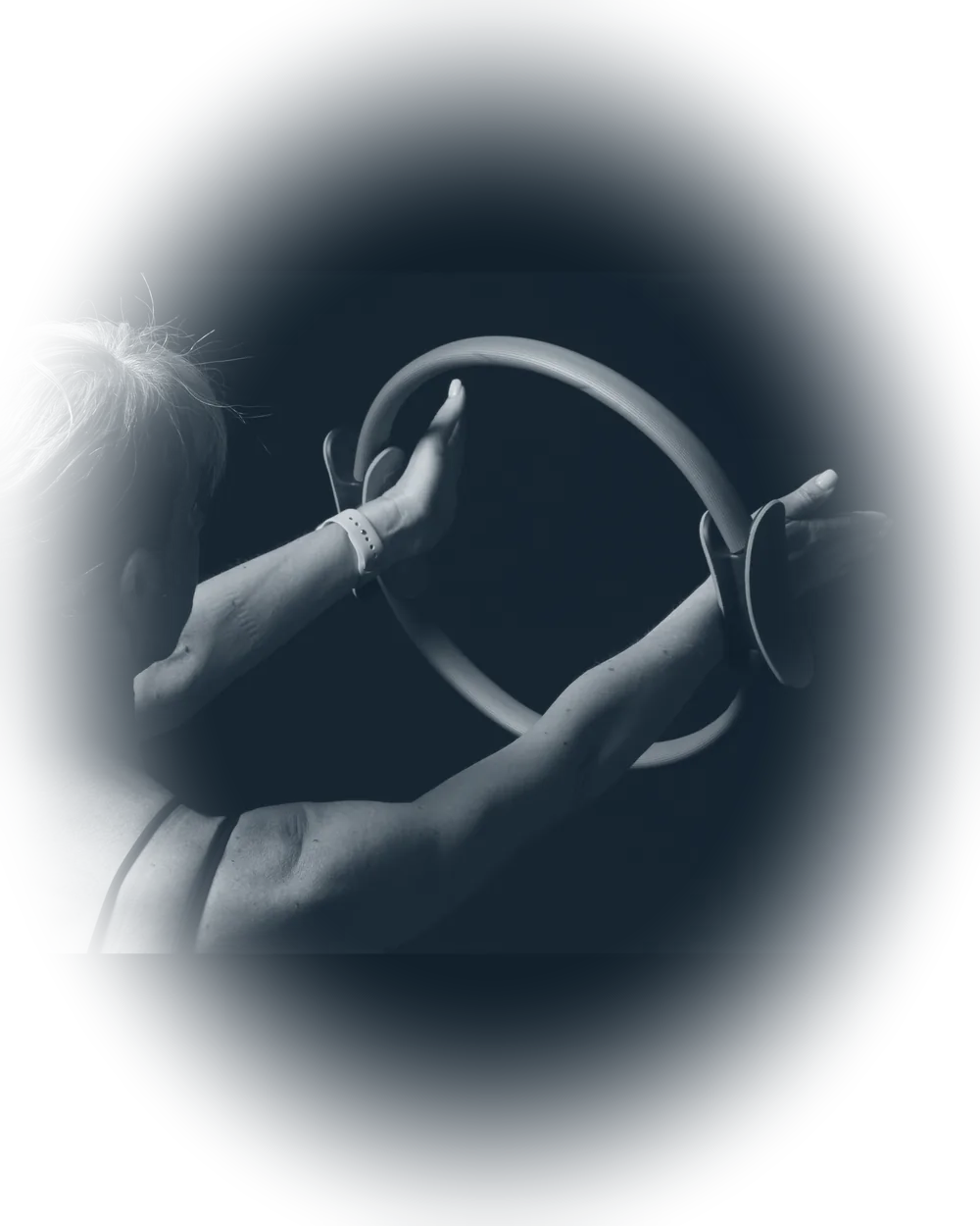 Florence holding a Pilates magic circle, dramatic black-and-white light